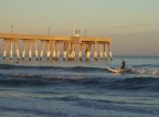  Catching a wave at sunset near Johnnie Mercer's pier