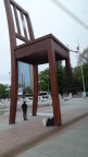  Anti-land mine activists have installed this huge chair on the UN Plaza in Geneva. Its left-front leg has been decimated by a normal-size land mine.